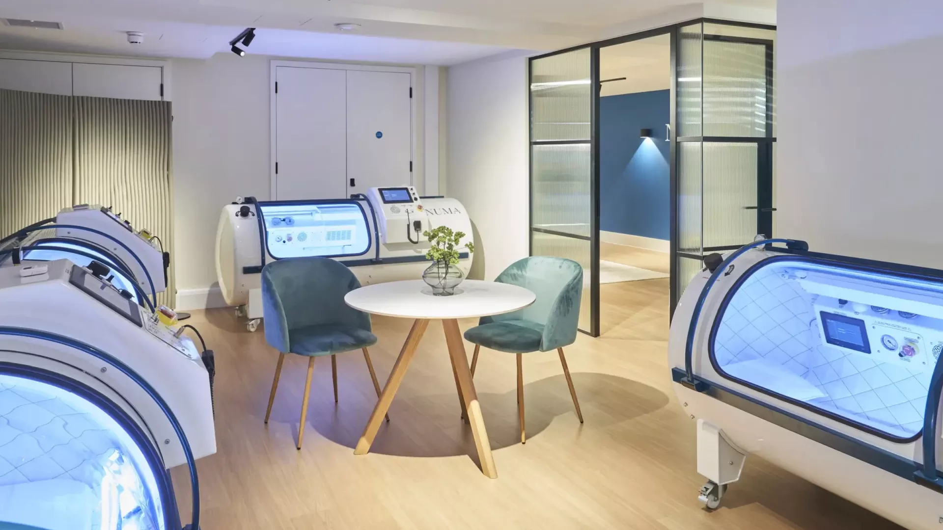 NUMA treatment room with three monoplace hyperbaric chambers and patient seating