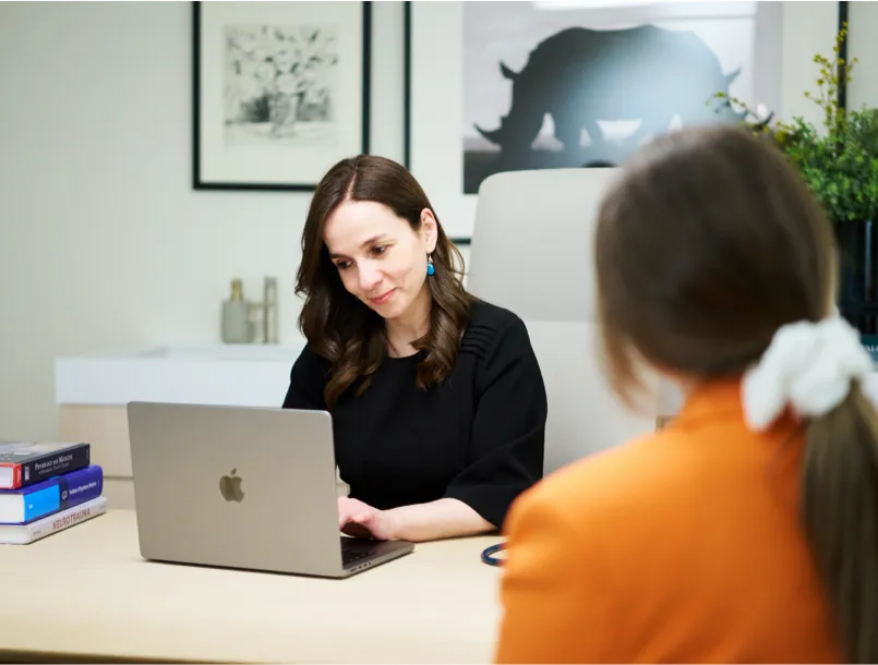 Consultant speaking with a patient during a medical consultation at NUMA